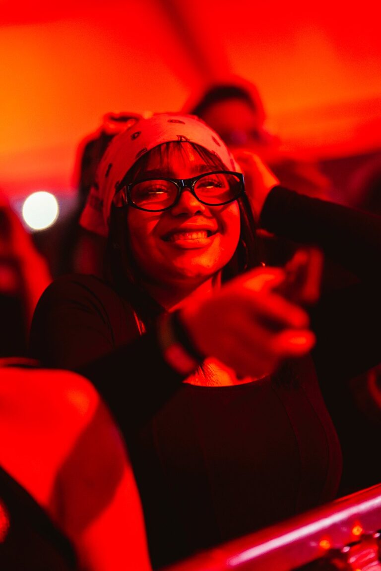 Chica con gafas sonriendo entre el público de Kybba